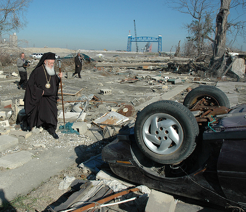 green-patriarch-bartholomew-new-orleans-destruction-car-wreck-rubble-january-7-2006-his-hll-holiness-ecumenical-black-robes-white-beard-walk-staff-clear-day-photo